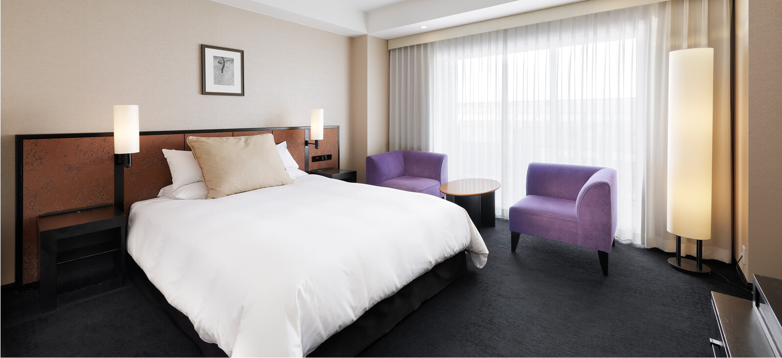 シンプルなインテリアのダブルルーム、紫のチェアが並ぶ窓辺